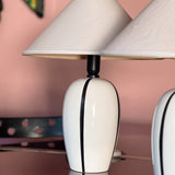 Pair of 1980s Italian G G Luce white ceramic lamps with black stripe
