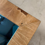 Large Italian burr wood coffee table with blue mirror top.