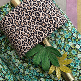 1970s pair of Tomasso Barbi leaf wall lights with leopard print shades