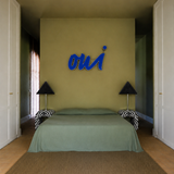 1990s cafe illuminated ‘OUI’ sign