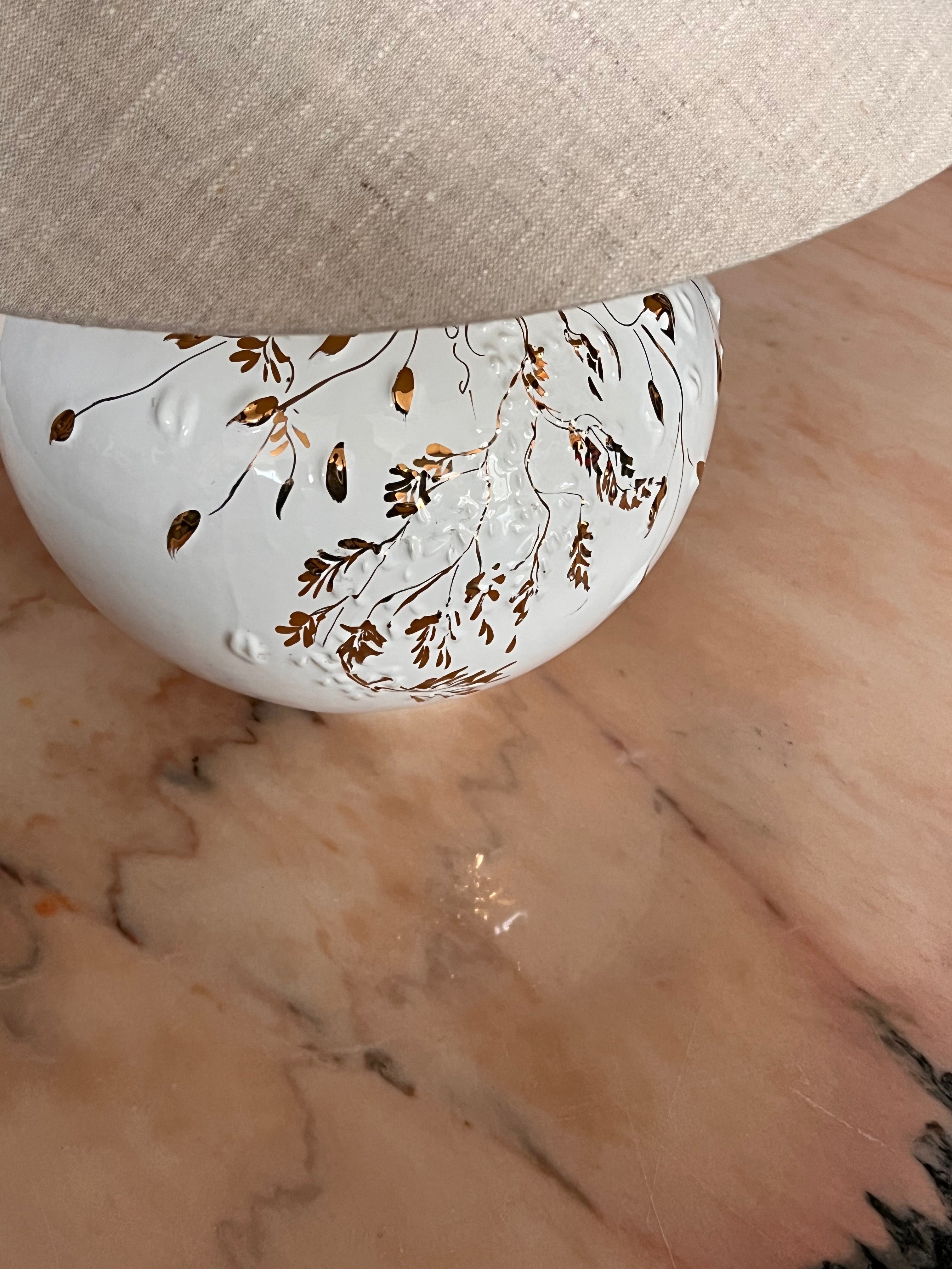 white and gold ceramic lamp